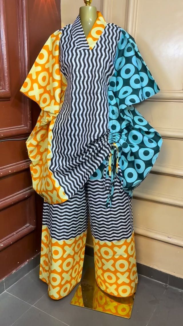 Two-piece matching set with bold yellow, blue, and black patterns on a mannequin.