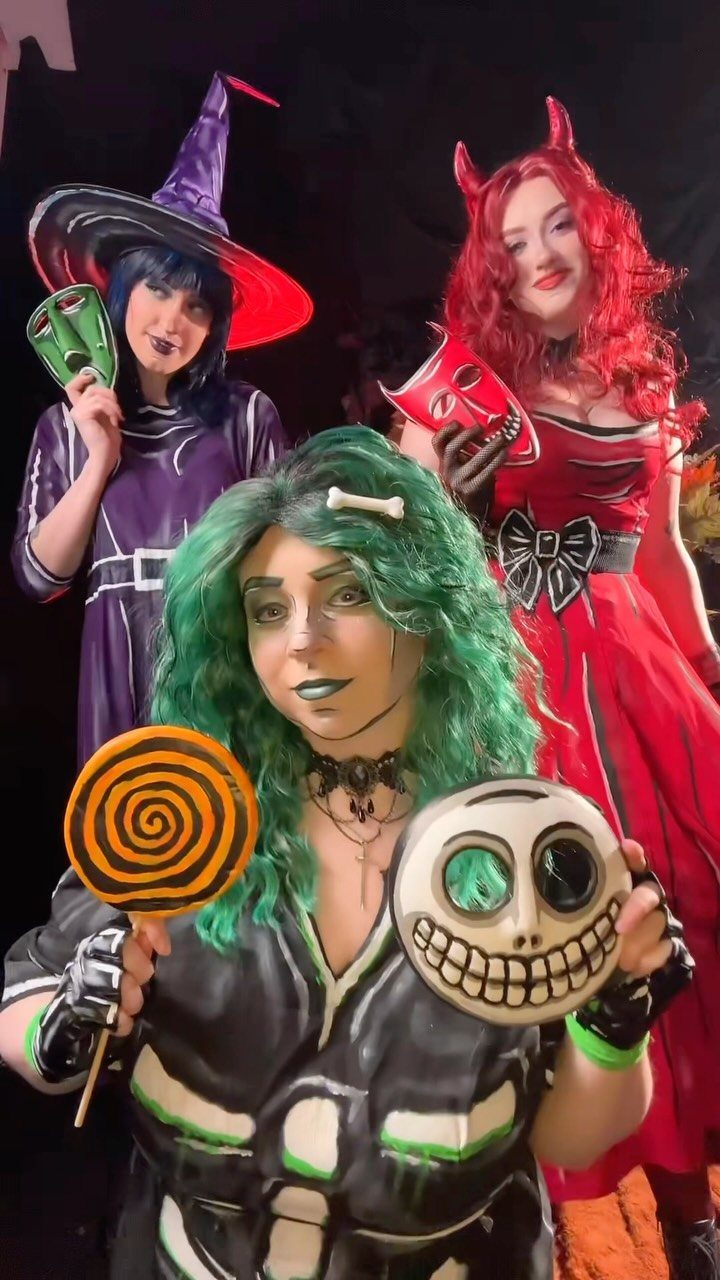 Three women dressed as Lock, Shock, and Barrel from The Nightmare Before Christmas.