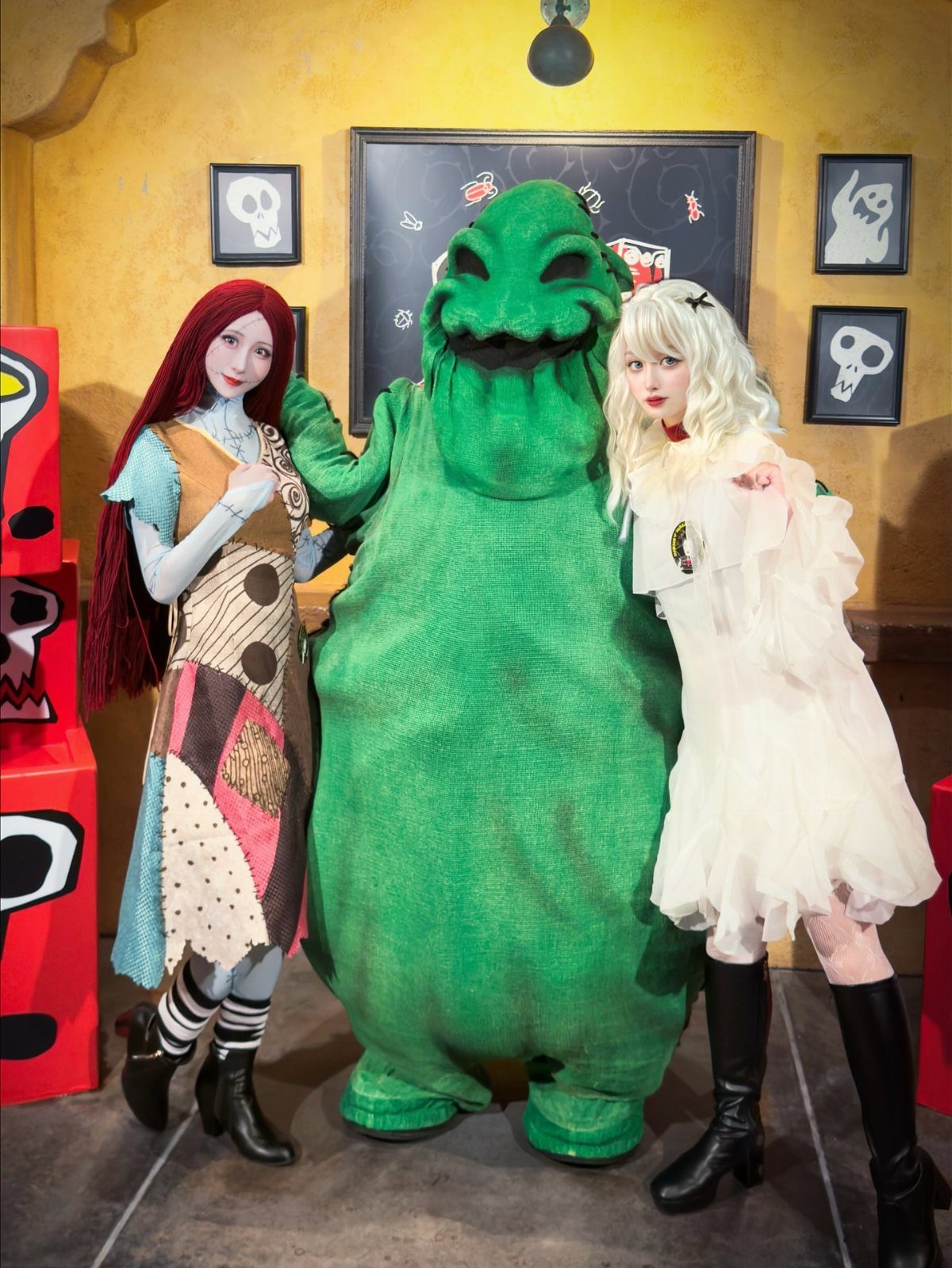 Three people in Nightmare Before Christmas costumes as Sally, Oogie Boogie, and Shock.