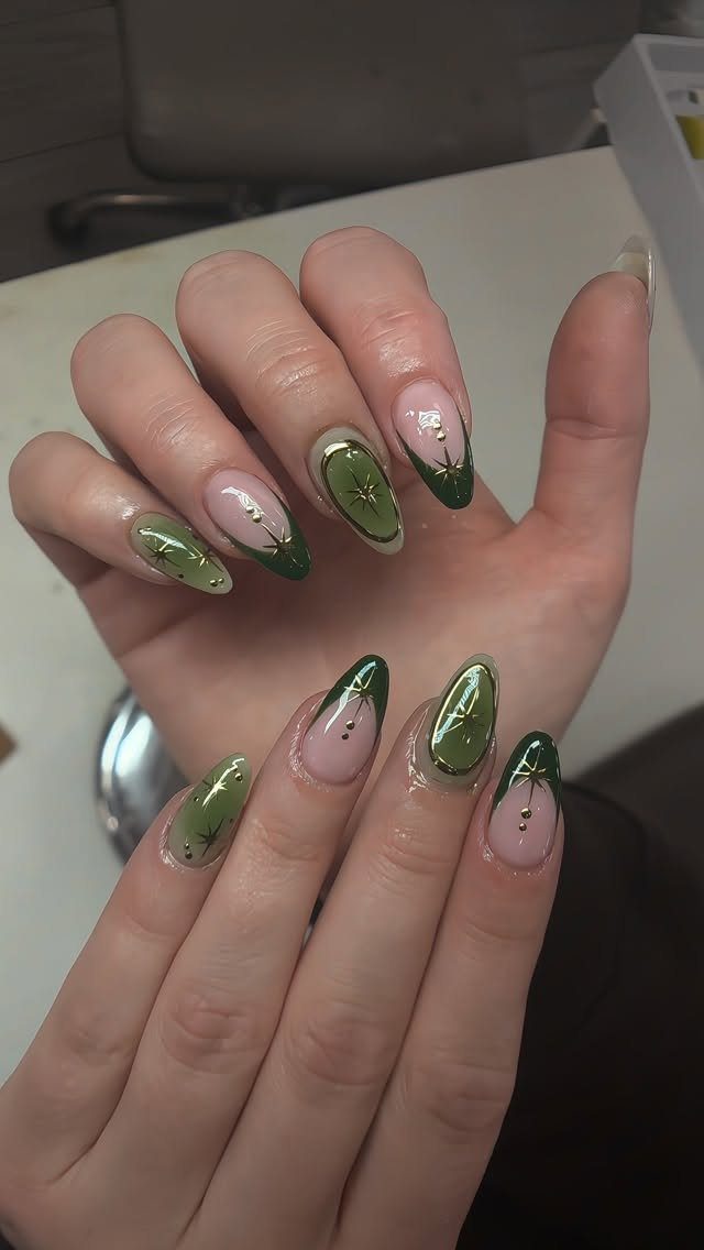 Almond nails with mixed green designs, gold accents, and French tips.