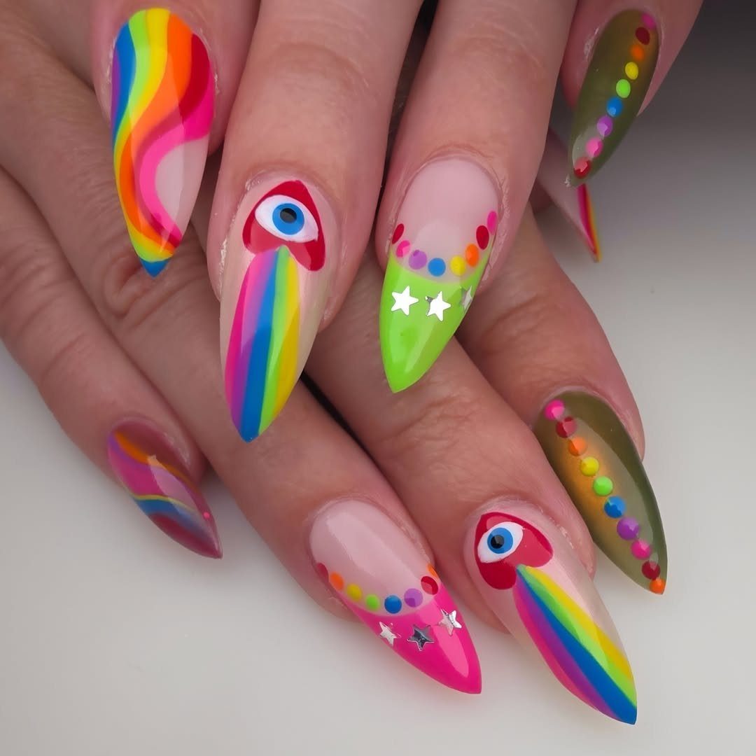 Almond nails with rainbow patterns, colorful dots, and eye motifs on fingers.