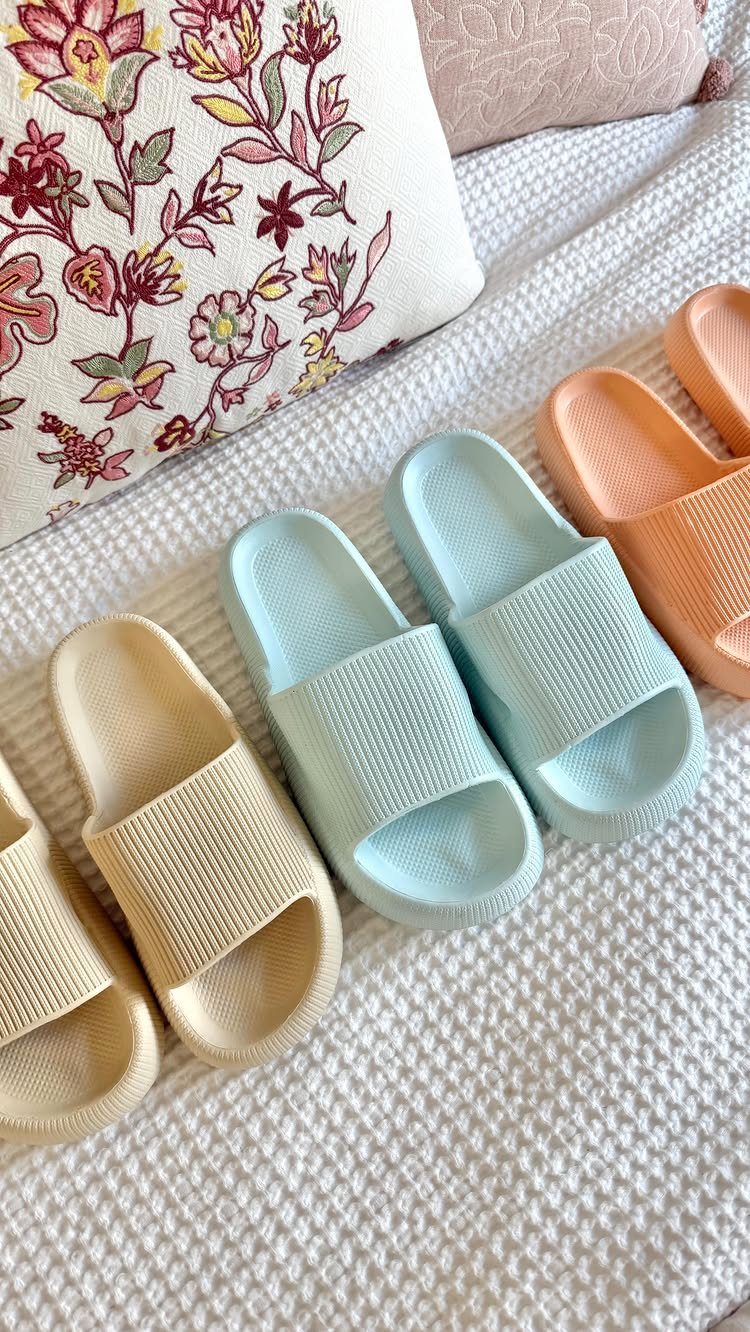 Cloud slides in cream, light blue, and peach on a white textured blanket.