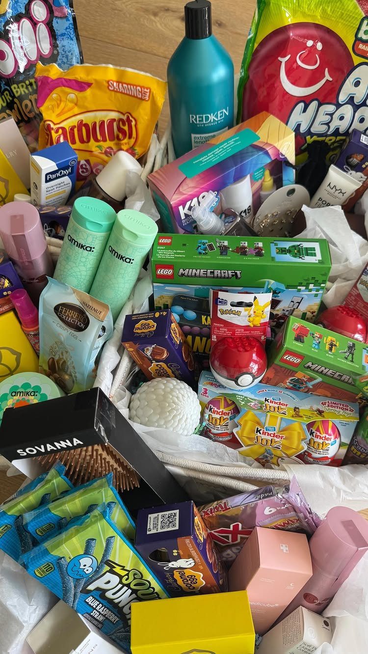 Gift basket filled with candy, LEGO sets, and beauty products for a teenager.