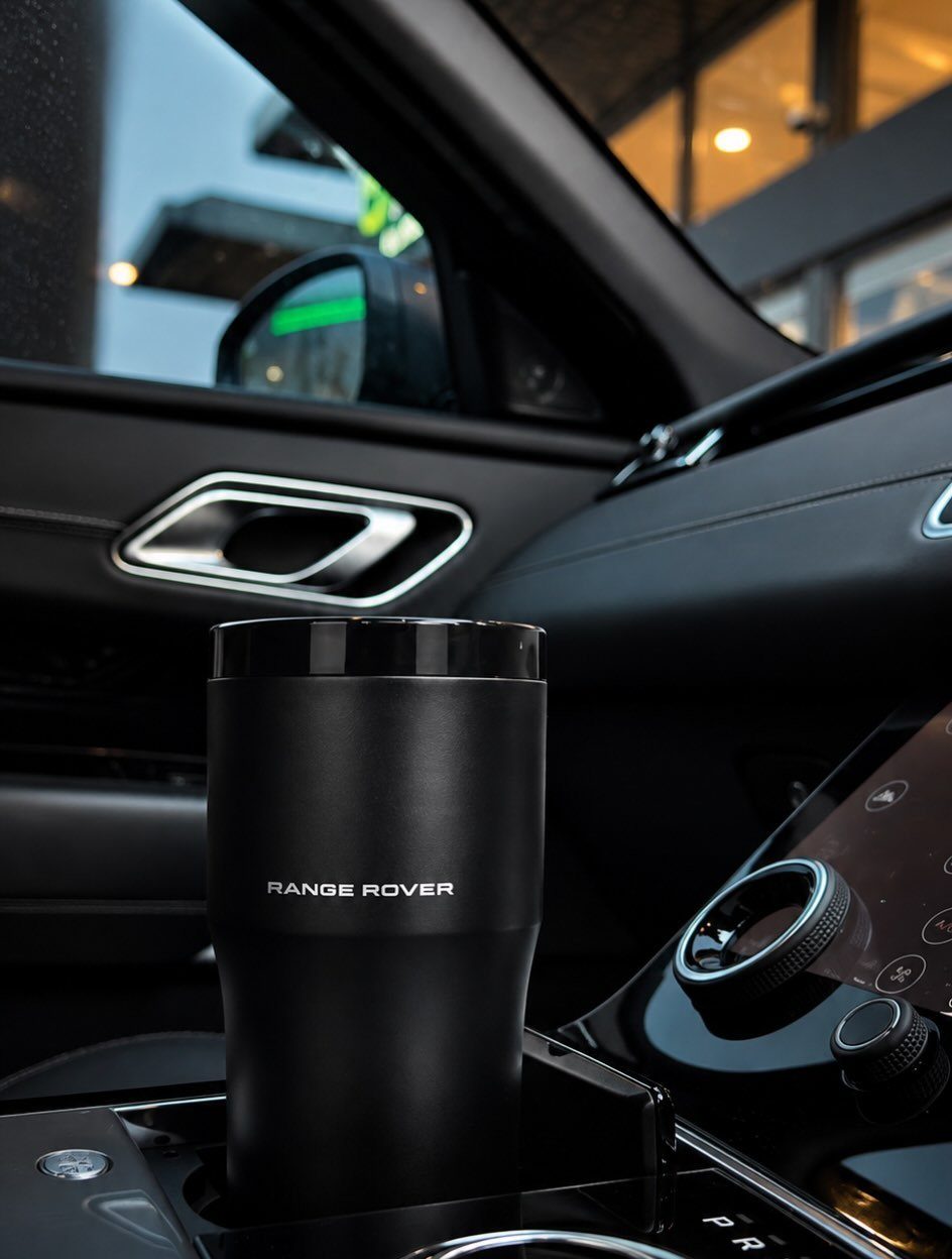 Matte black Range Rover insulated tumbler in a luxury car cup holder