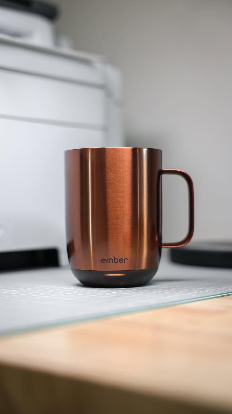 Copper metallic insulated Ember mug sitting on a light surface in a kitchen.