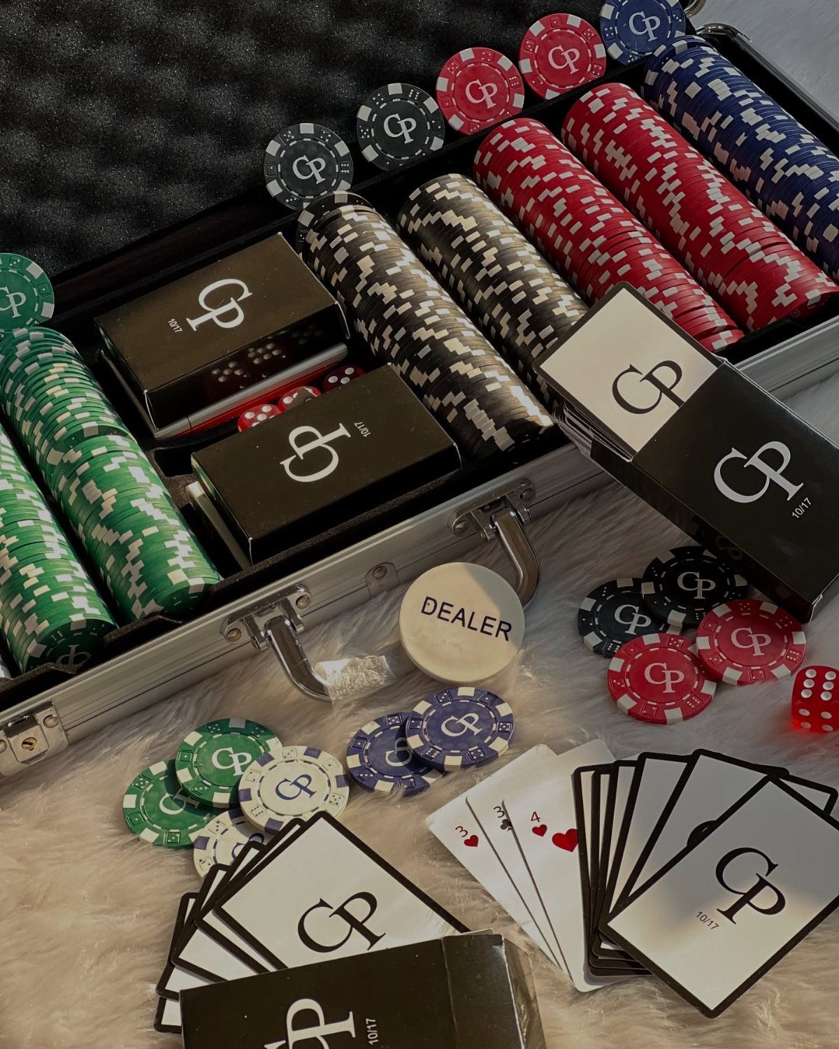 Personalized poker set with custom chips and cards in a silver aluminum case.