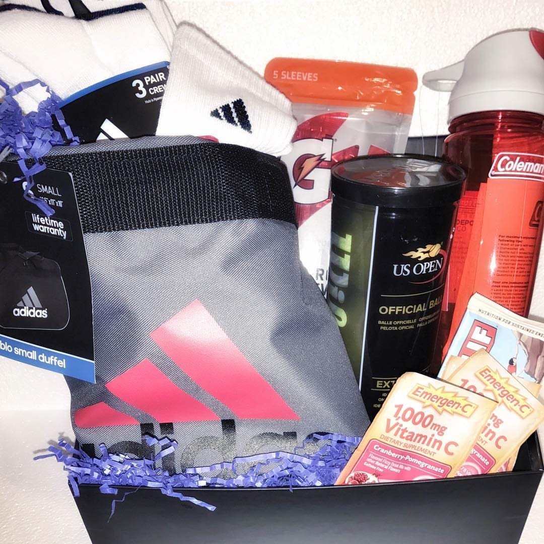 Sports themed gift basket with Adidas gear, tennis balls, and a water bottle.