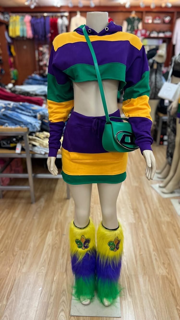 Mannequin wearing purple, green, and yellow Mardi Gras outfit with fluffy boots.